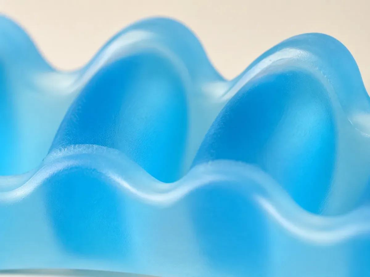 Extreme close-up of the blue translucent SEBS gel, light passing through the soft material