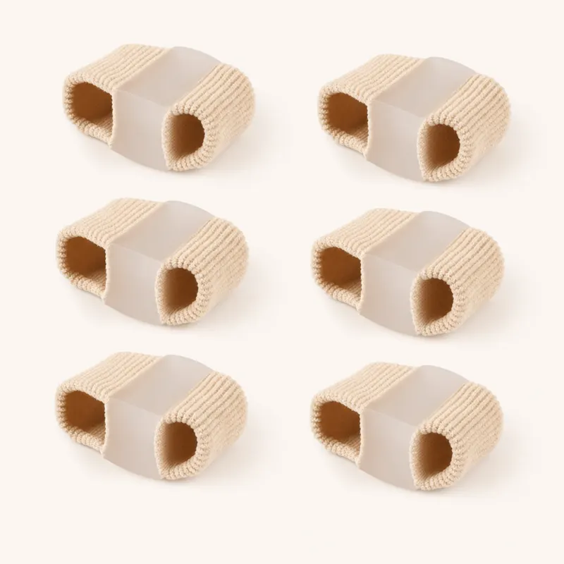 Six beige fabric-covered toe separator tubes